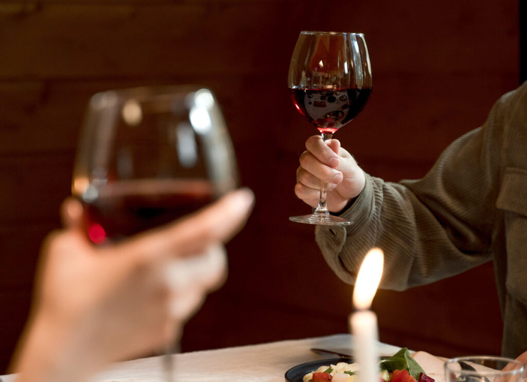 Duas pessoas brindando com taças de vinho